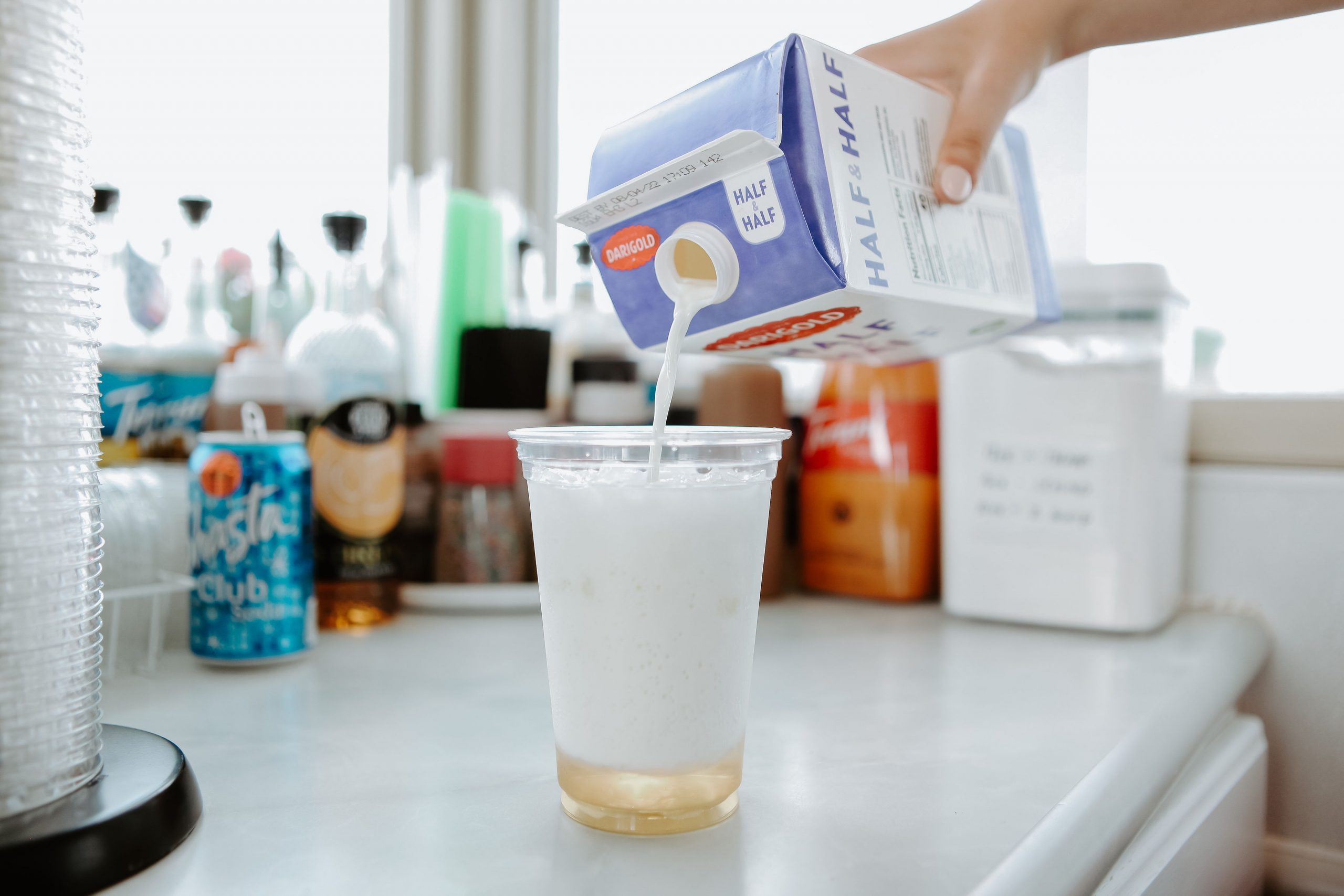 Pouring half & half into a cup.