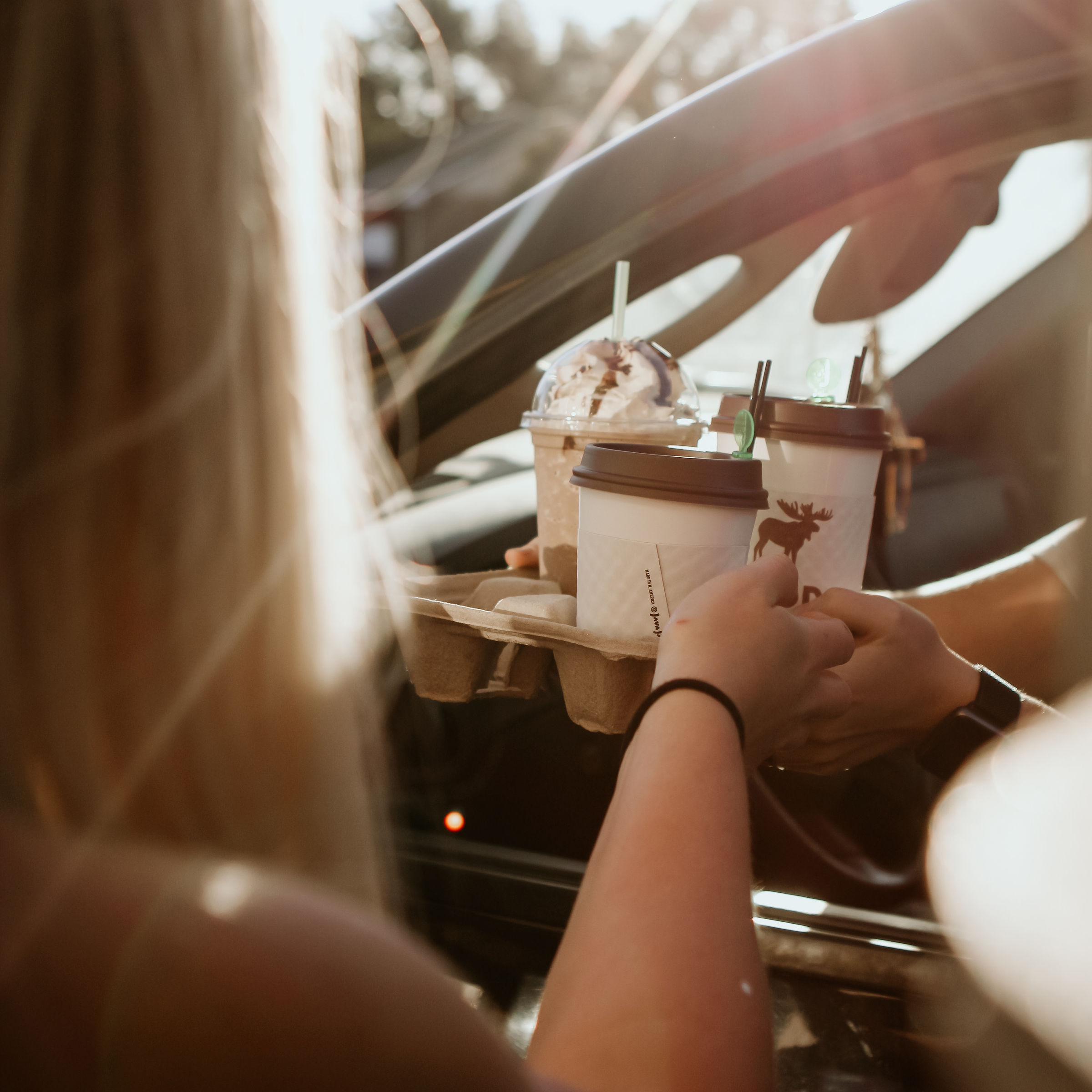 Handing drinks out the drive through window