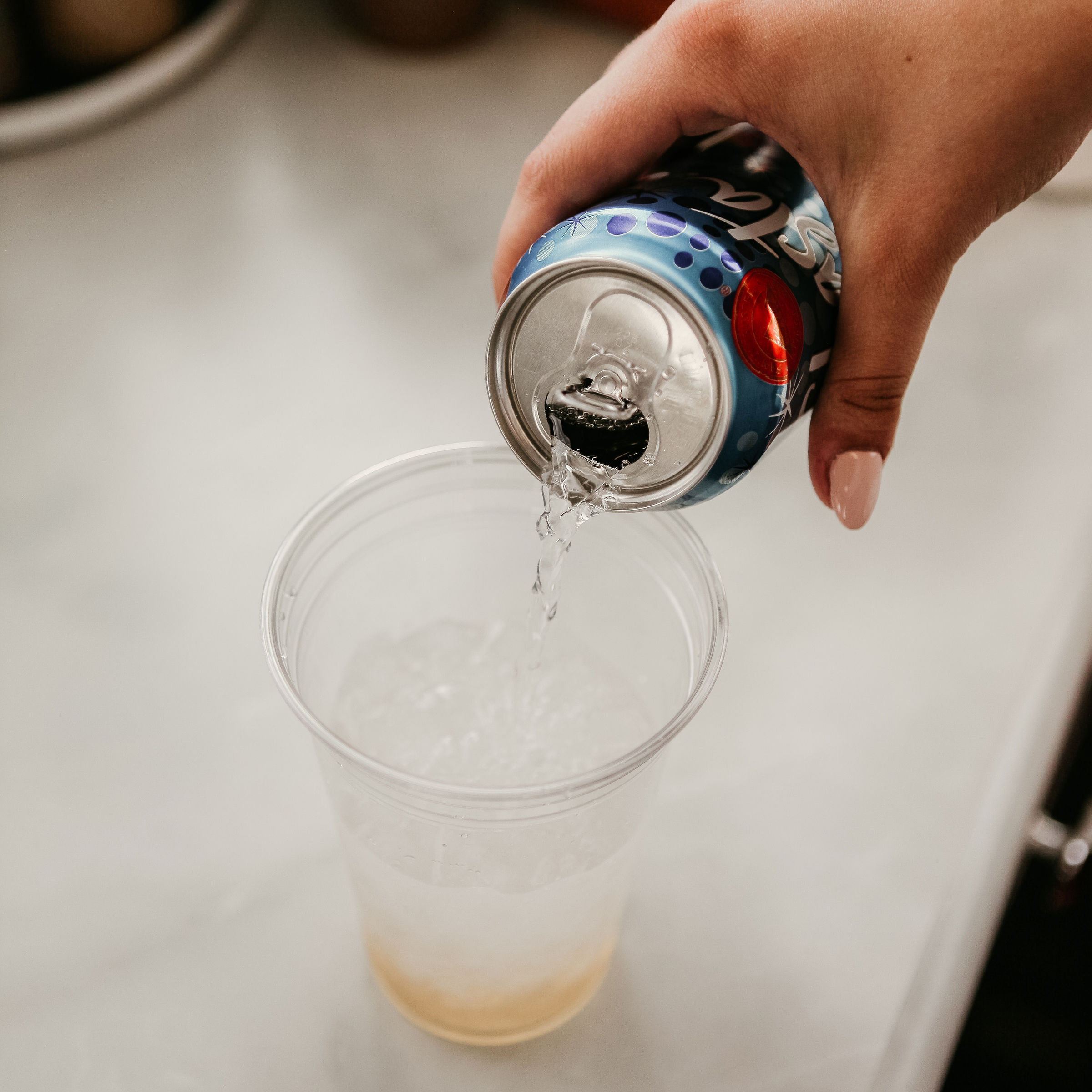 Pouring club soda into a cup